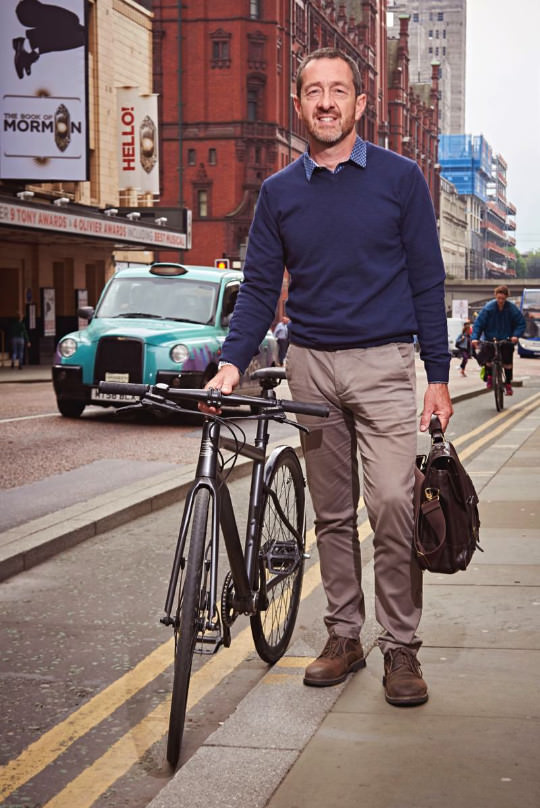 Chris Boardman standing with bike in Manchester