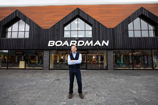 Chris Boardman standing outside Boardman Bikes showroom